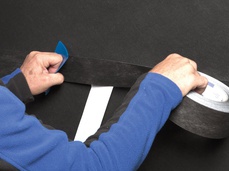 3. Pressing firmly to secure the tape!