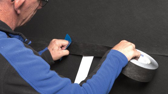 3. Rub the tape firmly to secure the adhesive bond